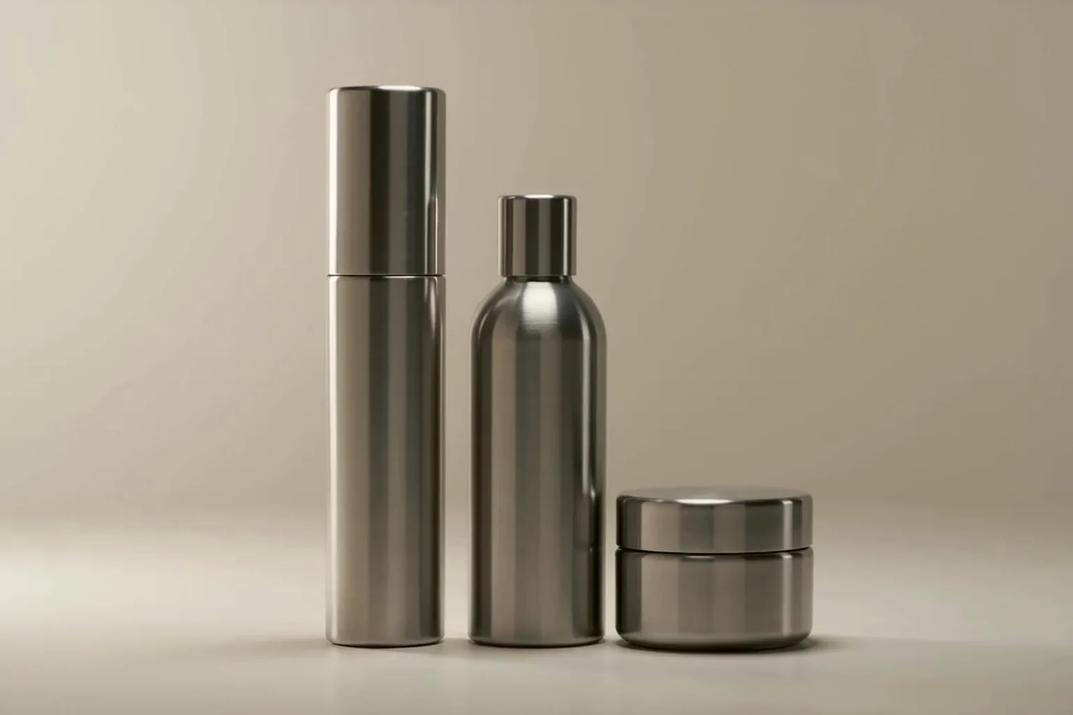 The cleanser, toner and cream together on a warm off-white ground